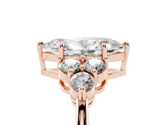 Marquise Cut Diamond Solitaire Ring Set in Rose gold with Cluster Accents on Each Side