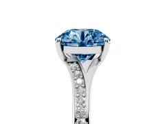 Fancy Blue Round Cut Diamond Solitaire Ring Set in White gold with Pavé Accent Band and Classic Prong Setting