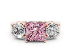 Fancy Pink Princess Cut Diamond Three-Stone Ring Set in Rose gold with Round Side Stones and Classic Band