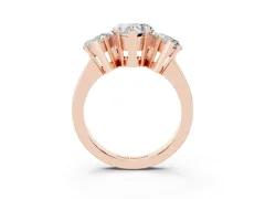 Heart Cut Diamond Three-Stone Ring Set in Rose gold with Channel-Set Band and Prong Settings