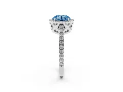 Fancy Blue Round Cut Diamond Halo Ring Set in Platinum with Pavé Shoulders and Halo-Framed Center