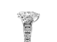 Pear Cut Diamond Three-Stone Ring Set in White gold with Round Side Stones and Delicate Pavé Band