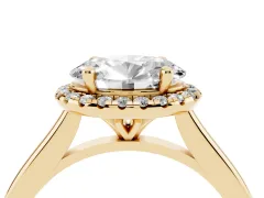 Oval Cut Diamond Halo Engagement Ring Set in Yellow gold with Pavé Band and Rising Shoulders