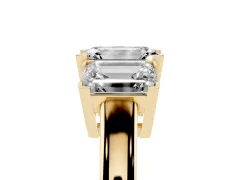 Emerald Cut Diamond Three-Stone Ring Set in Yellow gold with Channel-Set Band and Prong Settings