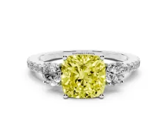 Fancy Yellow Cushion Cut Diamond Three-Stone Ring Set in Platinum with Pavé Band and Graduated Sides