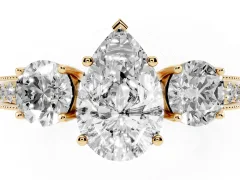 Pear Cut Diamond Three-Stone Ring Set in Yellow gold with Round Side Stones and Pavé Band
