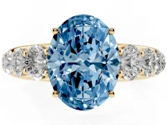 Fancy Blue Oval Cut Diamond Solitaire Ring Set in Yellow gold with Pavé-Set Band and Prong Setting