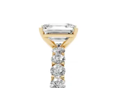 Emerald Cut Diamond Solitaire Ring Set in Yellow gold with Shared Prong Pavé Band
