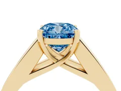 Fancy Blue Cushion Cut Diamond Solitaire Ring Set in Yellow gold with Channel-Set Accent Stones and Prong Setting