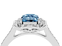 Fancy Blue Emerald Cut Diamond Halo Ring Set in Platinum with Pavé-Lined Shoulders and Prong Setting