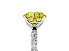 Fancy Yellow Round Cut Diamond Solitaire Engagement Ring Set in Platinum with Round Pavé Band and Prong Setting