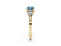 Fancy Blue Cushion Cut Diamond Three-Stone Ring Set in Yellow gold with Pavé Band and Smaller Side Stones