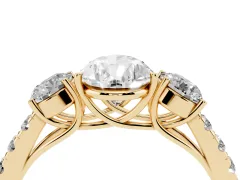 Pear Cut Diamond Three-Stone Ring Set in Yellow gold with Round Side Stones and Delicate Pavé Band