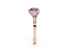 Fancy Pink Heart Cut Diamond Three-Stone Ring Set in Rose gold with Pavé Band and Smaller Side Stones