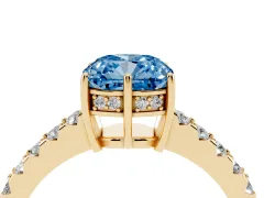 Fancy Blue Cushion Cut Diamond Solitaire Engagement Ring Set in Yellow gold with Pavé Band and Prong Setting
