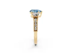 Fancy Blue Pear Cut Diamond Three-Stone Ring Set in Yellow gold with Round Side Stones and Pavé Band