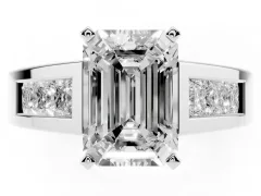 Emerald Cut Diamond Solitaire Ring Set in White gold with Channel-Set Accent Stones and Prong Setting