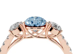 Fancy Blue Pear Cut Diamond Three-Stone Ring Set in Rose gold with Round Side Stones and Delicate Pavé Band
