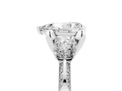Pear Cut Diamond Three-Stone Ring Set in Platinum with Pavé Band and Smaller Side Stones