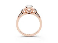 Pear Cut Diamond Three-Stone Ring Set in Rose gold with Pavé Band and Smaller Side Stones