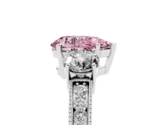 Fancy Pink Pear Cut Diamond Three-Stone Ring Set in Platinum with Round Side Stones and Pavé Band