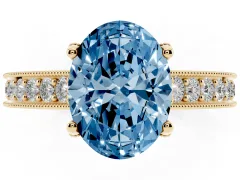 Fancy Blue Oval Cut Diamond Solitaire Ring Set in Yellow gold with Milgrain-Edged Pavé Band and Prong Setting