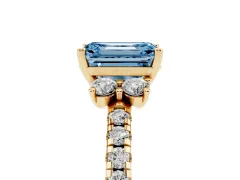 Fancy Blue Emerald Cut Diamond Three-Stone Pavé Ring Set in Yellow gold with Prong Setting