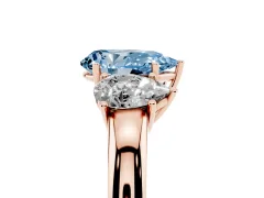 Fancy Blue Pear Cut Diamond Three-Stone Ring Set in Rose gold with Bold Center and Classic Band