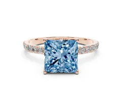 Fancy Blue Princess Cut Diamond Solitaire Engagement Ring Set in Rose gold with Round Pavé Band and Prong Setting