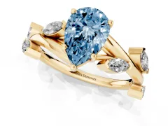 Fancy Blue Pear Cut Diamond Solitaire Ring Set in Yellow gold with Twisted Marquise Accent Band