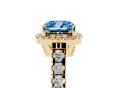 Fancy Blue Cushion Cut Diamond Halo Engagement Ring Set in Yellow gold with Pavé Band and Prong-Set Center