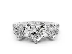 Heart Cut Diamond Three-Stone Ring Set in White gold with Channel-Set Band and Prong Settings