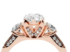 Pear Cut Diamond Three-Stone Ring Set in Rose gold with Pavé Band and Smaller Side Stones