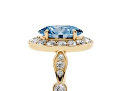 Fancy Blue Oval Cut Diamond Halo Engagement Ring Set in Yellow gold with Twisted Band and Prong Setting