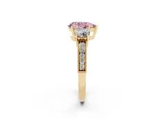 Fancy Pink Pear Cut Diamond Three-Stone Ring Set in Yellow gold with Round Side Stones and Pavé Band