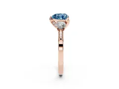 Fancy Blue Heart Cut Diamond Three-Stone Ring Set in Rose gold with Pavé Band and Smaller Side Stones