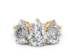 Pear Cut Diamond Three-Stone Ring Set in Yellow gold with Channel-Set Band and Prong Settings