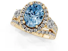 Fancy Blue Oval Cut Diamond Halo Split Shank Ring Set in Yellow gold with Round Accent Stones and Prong Setting