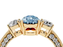 Fancy Blue Pear Cut Diamond Three-Stone Ring Set in Yellow gold with Round Side Stones and Pavé Band