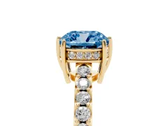 Fancy Blue Cushion Cut Diamond Solitaire Engagement Ring Set in Yellow gold with Pavé Band and Prong Setting