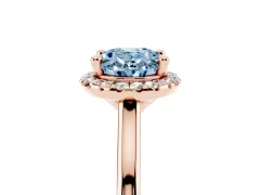 Fancy Blue Oval Cut Diamond Halo Engagement Ring Set in Rose gold with Pavé Band and Rising Shoulders