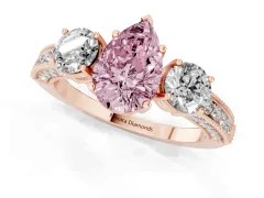 Fancy Pink Pear Cut Diamond Three-Stone Ring Set in Rose gold with Round Side Stones and Pavé Band