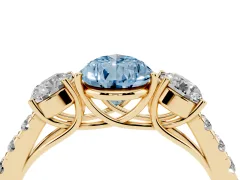 Fancy Blue Pear Cut Diamond Three-Stone Ring Set in Yellow gold with Round Side Stones and Delicate Pavé Band