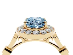 Fancy Blue Oval Cut Diamond Halo Engagement Ring Set in Yellow gold with Twisted Band and Prong Setting
