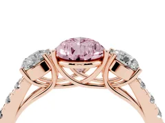 Fancy Pink Pear Cut Diamond Three-Stone Ring Set in Rose gold with Round Side Stones and Delicate Pavé Band
