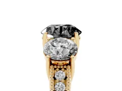 Fancy Black Round Cut Diamond Three-Stone Engagement Ring Set in Yellow gold with Milgrain Pavé Band
