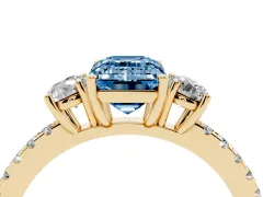 Fancy Blue Emerald Cut Diamond Three-Stone Ring Set in Yellow gold with Pavé Band and Graduated Sides