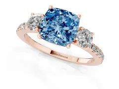 Fancy Blue Cushion Cut Diamond Three-Stone Ring Set in Rose gold with Pavé Band and Graduated Sides