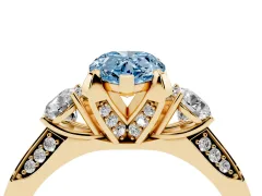 Fancy Blue Pear Cut Diamond Three-Stone Ring Set in Yellow gold with Pavé Band and Smaller Side Stones