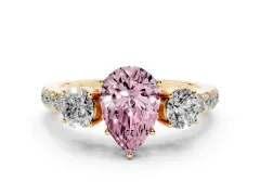Fancy Pink Pear Cut Diamond Three-Stone Ring Set in Yellow gold with Round Side Stones and Delicate Pavé Band